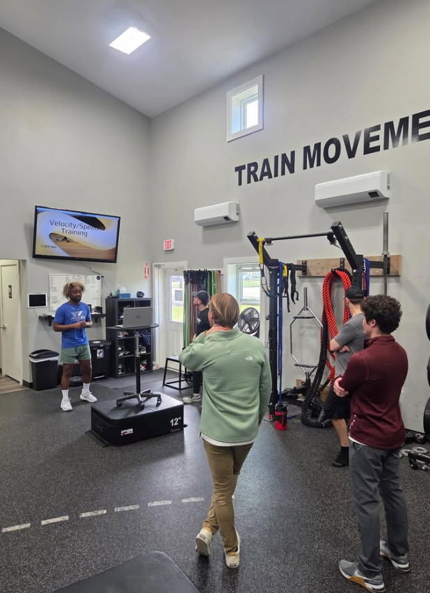 Prime360 coach presenting a speed training session to a group of attendees on the training floor